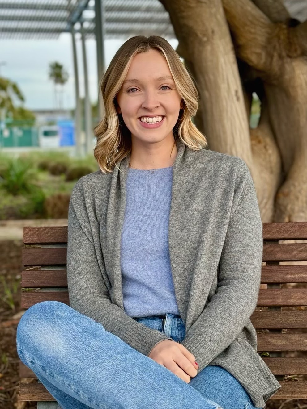 Isabel Simon smiling on a park bench